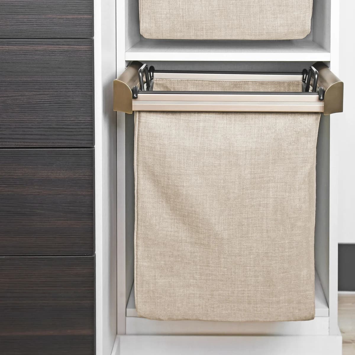 A fabric laundry hamper on a pull-out wardrobe frame